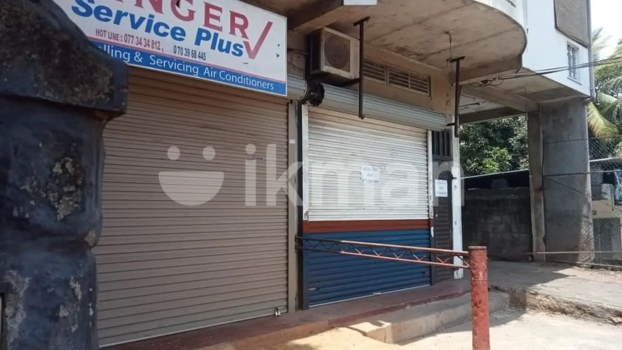 Close up on a plate of mashed potatoes, topped with baked pork chops with cream of mushroom soup, and a side of green beans.