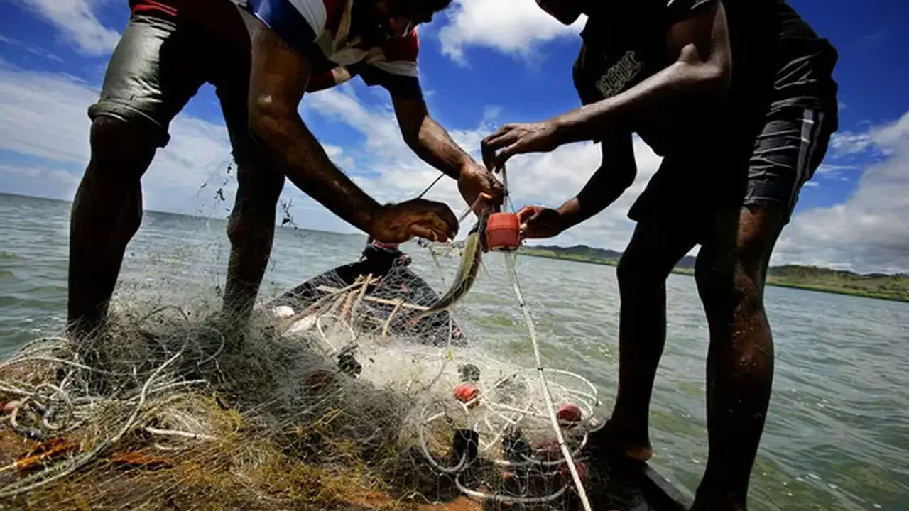 Close up on a plate of mashed potatoes, topped with baked pork chops with cream of mushroom soup, and a side of green beans.