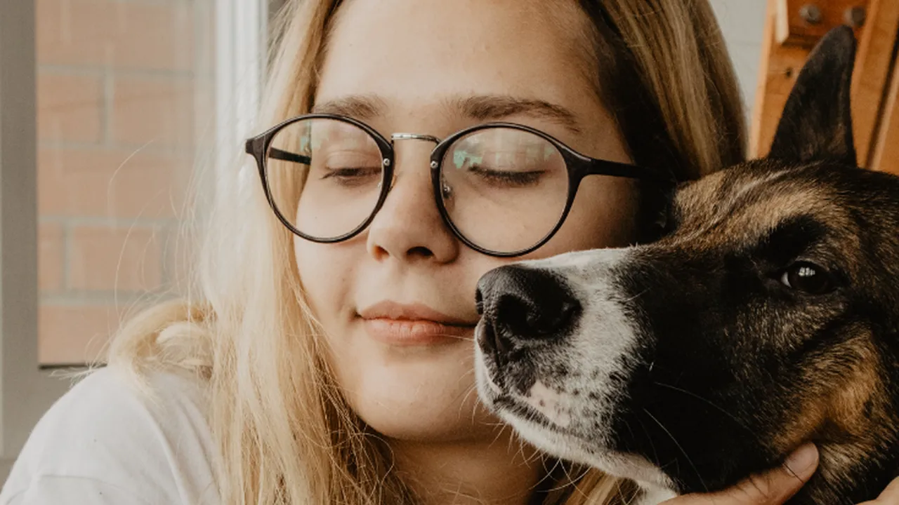 Close up on a plate of mashed potatoes, topped with baked pork chops with cream of mushroom soup, and a side of green beans.