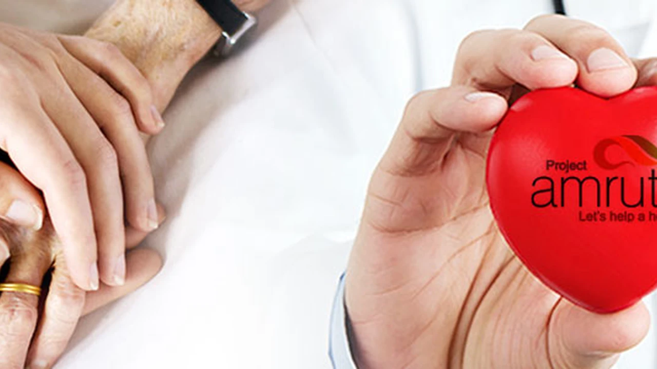Close up on a plate of mashed potatoes, topped with baked pork chops with cream of mushroom soup, and a side of green beans.