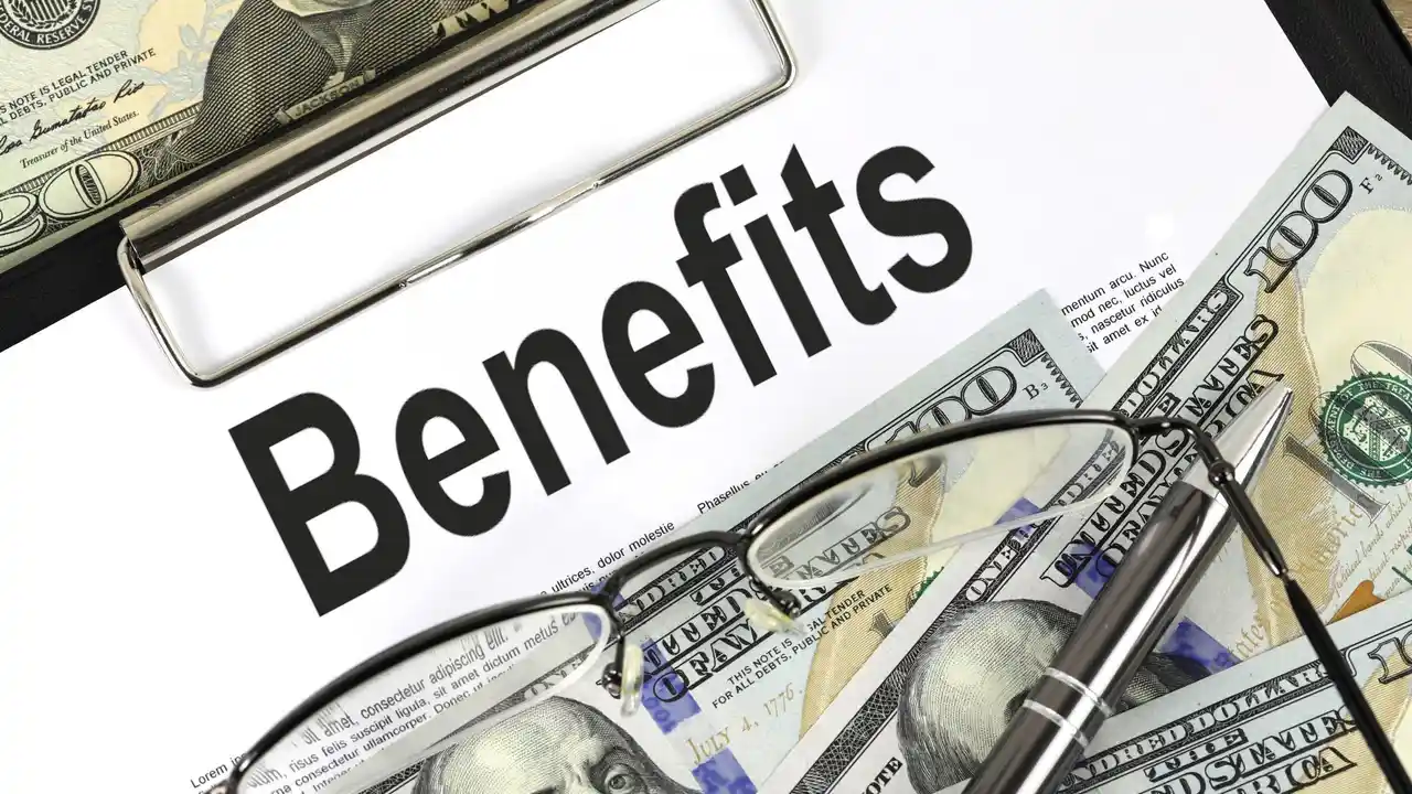 Two mint chocolate milkshakes with whipped cream and green sprinkles.